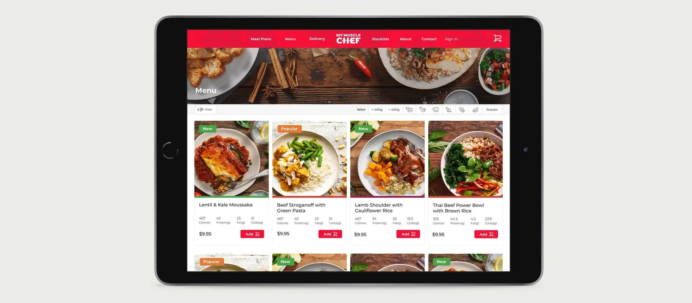 The redesigned My Muscle Chef menu page on a tablet: a grid of meal cards, each with a photo, name, macros, price and an add button.